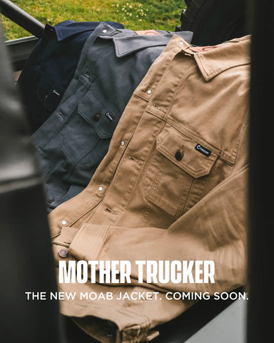 Brown jacket with 'Mother Trucker' branding and text about a new Moab jacket, set against a blurred outdoor background.